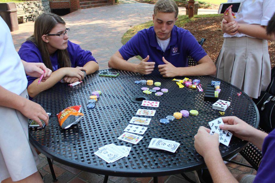 Winning a game during Casino Day requires the study of peers and cards. Sophomores Kacey Kemp and Roth Wilcox intently participated in Casino Day activities.  