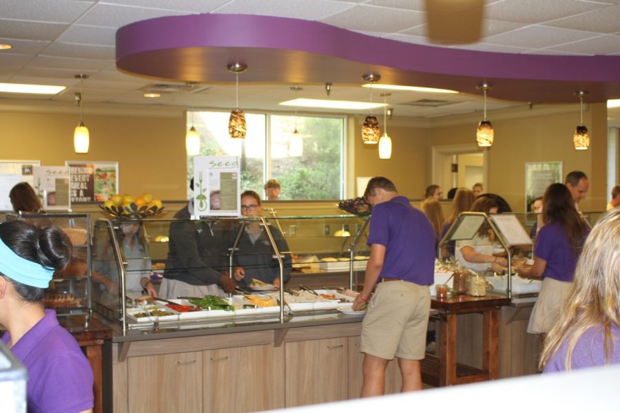 Our cafeteria is in many ways the center of student life. Students stand crowded in the lunchroom. 