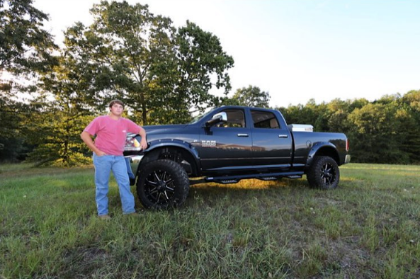 Jake Womack with his truck Big Dirty getting his senior pictures taken by Ruthanne Anderson. 