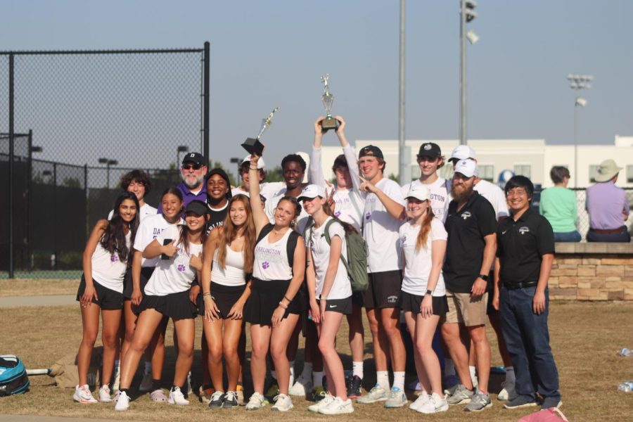 The varsity tennis team holding up their trophies after winning the regional championship at the Rome Tennis Center on Thursday, March 30th.