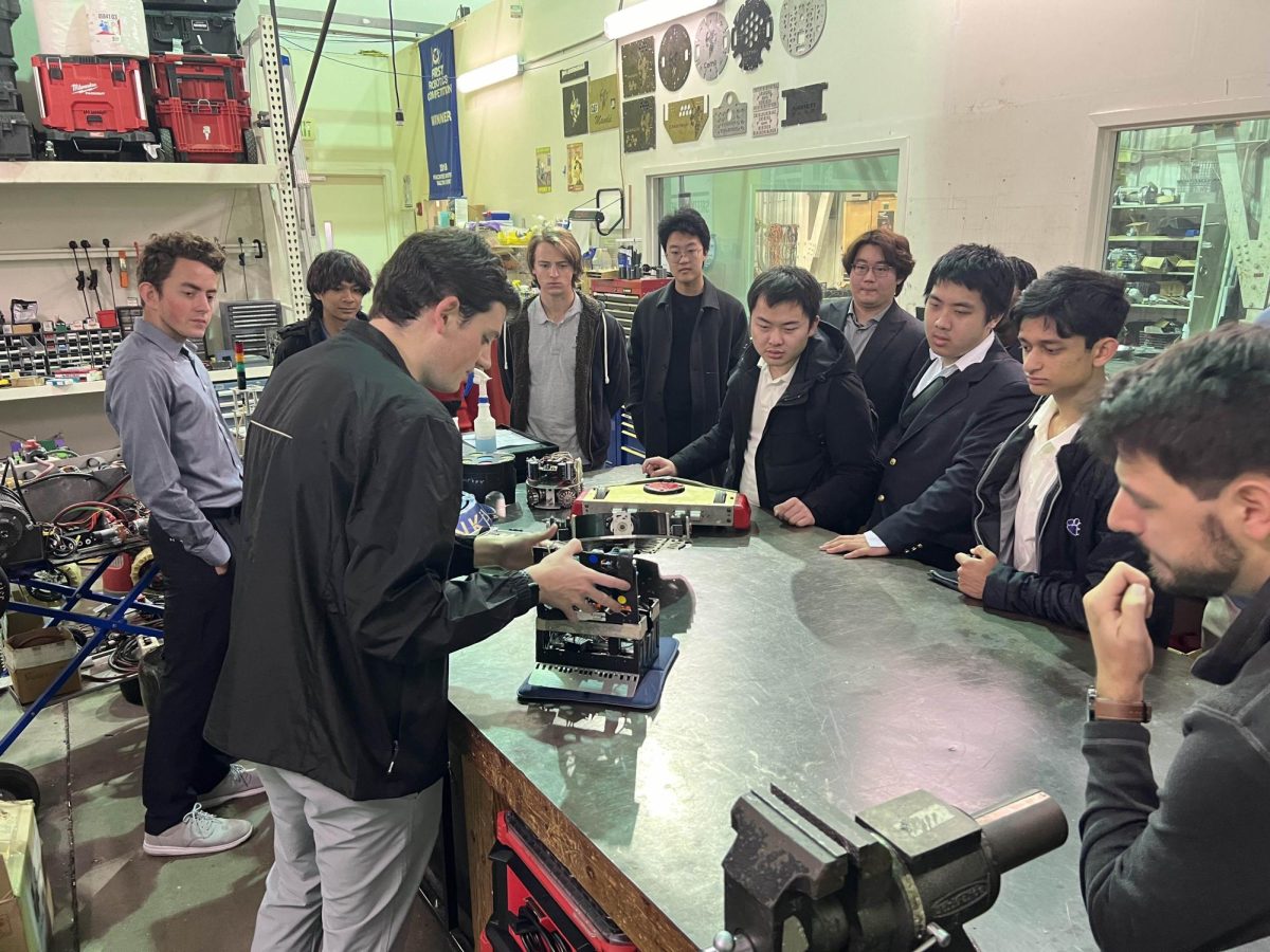 Members of the DarBots gather around a robot during their trip to Georgia Tech