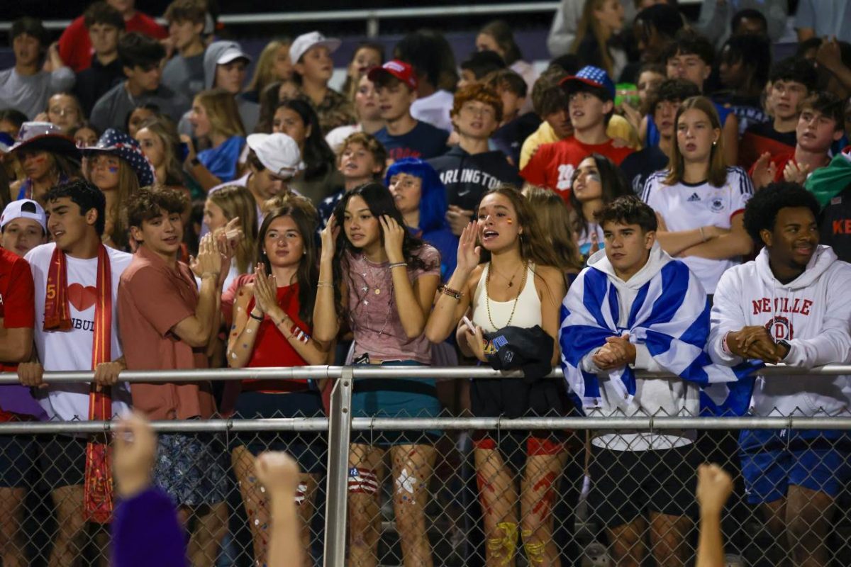 The student section cheers on the football team for theire big win against Pepperell on Sept 27.