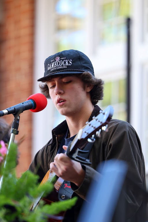 Winston Twenge plays the guitar and sings with his fellow band members during the Discover Day celebrations on Nov. 15.