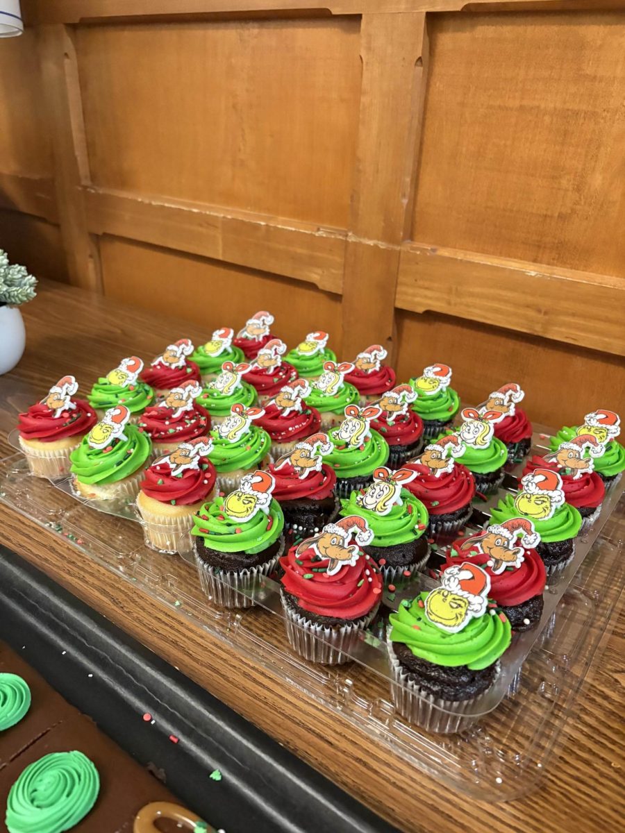 Students make cupcakes as a Christmas festivity.