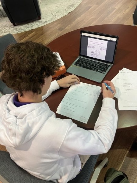 Sophomore Emmett Holcombe does homework on January 15.