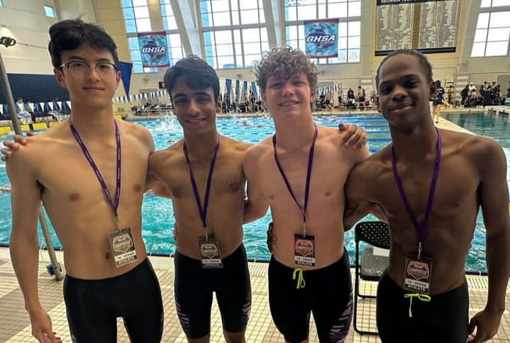 Seniors Jiahao Luo and Rayan Maqbool, sophomore Will Willerson and junior Sammy Lewis pose before their races.