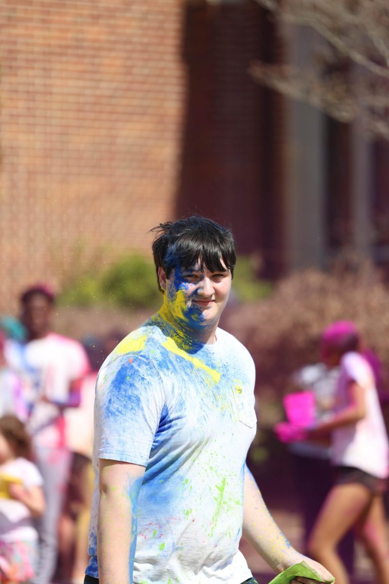 Junior Harrison Inman celebrates Holi on the Chapel Lawn on March 14.