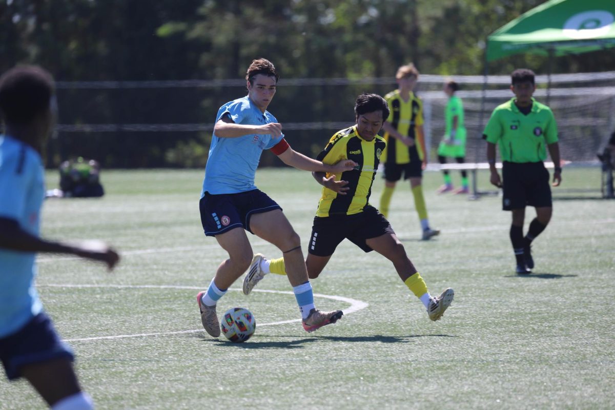 Junior. Lance Carroll, dribbles down the field