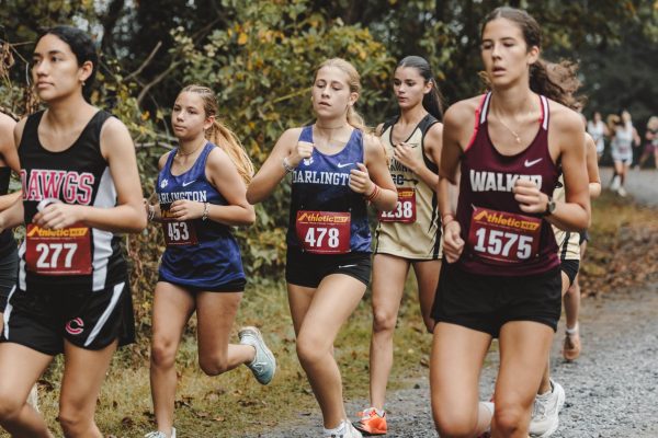Sophomore Adriana Baeza and freshman Daniela Lopez-Espejo Panos race together at the Darlington Cross Country Festival.
