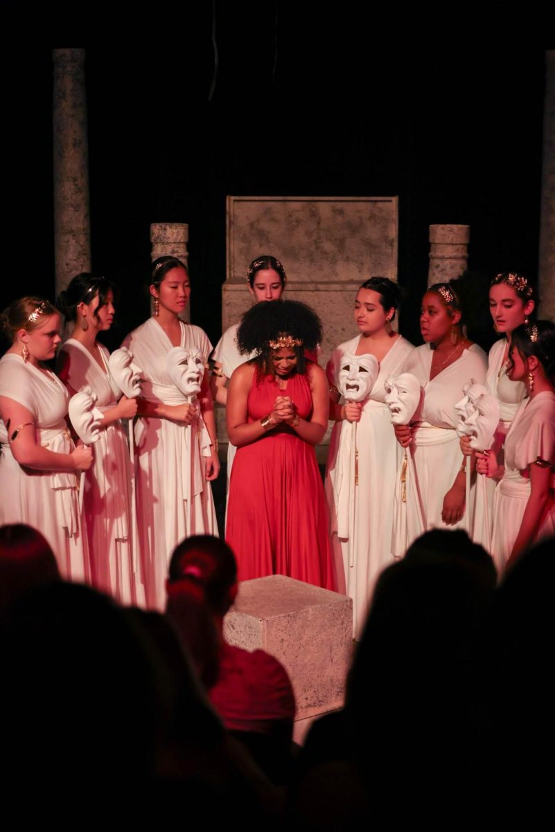 Senior Temira Bolds surrounded by other actors in the fall play, Antigone.