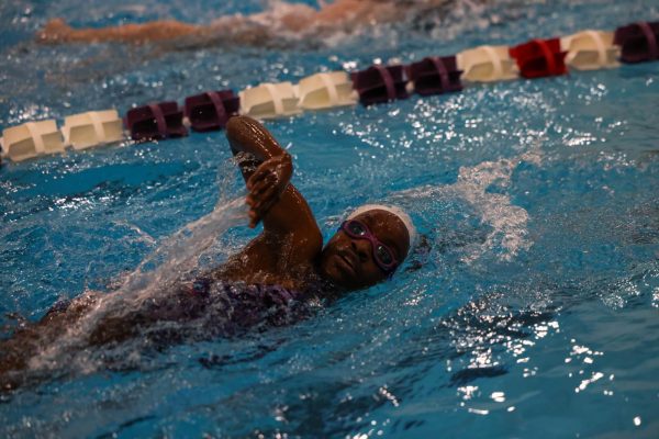 Senior Makayla Edorhe swims at senior night meet from last season.
