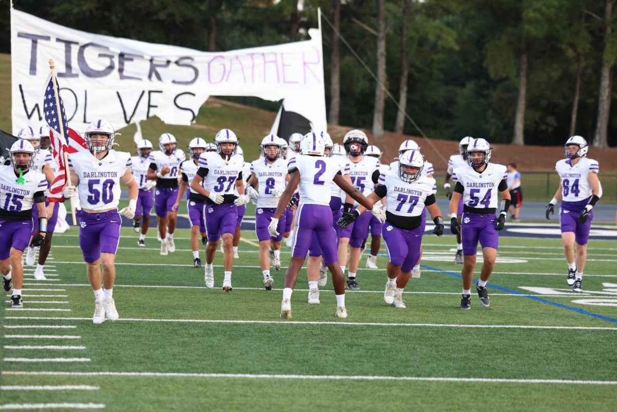 Varsity football loads the field before their game versus Whitefield Academy.