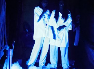 Dorm leaders getting in position to scare people walking through the haunted house.