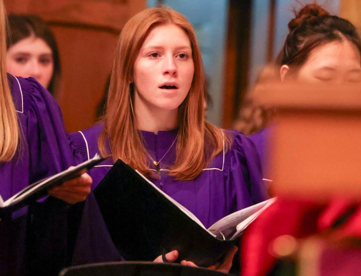 Senior Ava Ann Woods sings in the upper school choir at Lessons and Carols.