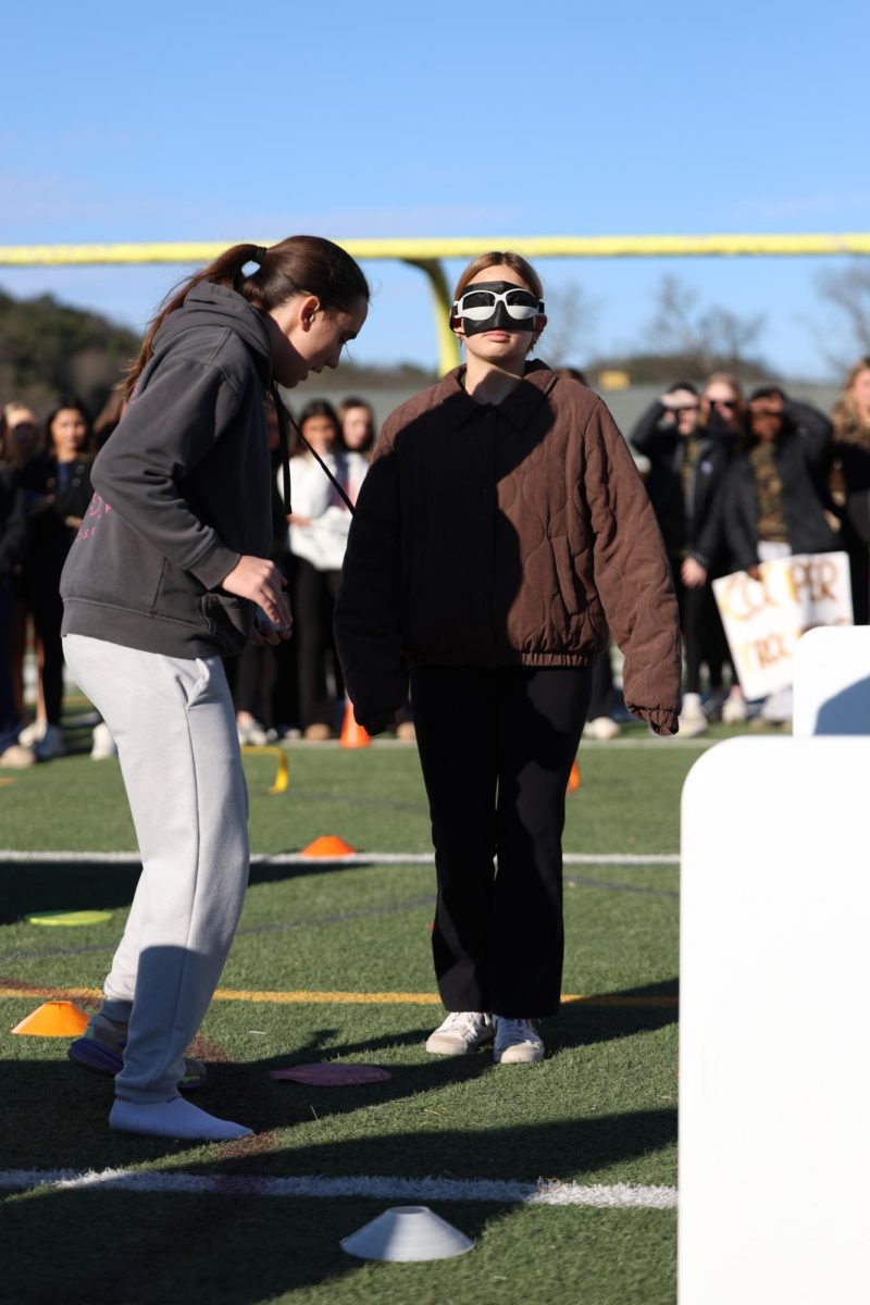 Iraia Sulibarria Rojas guides blindfolded teammate Adriana Baeza through an obstacle course.