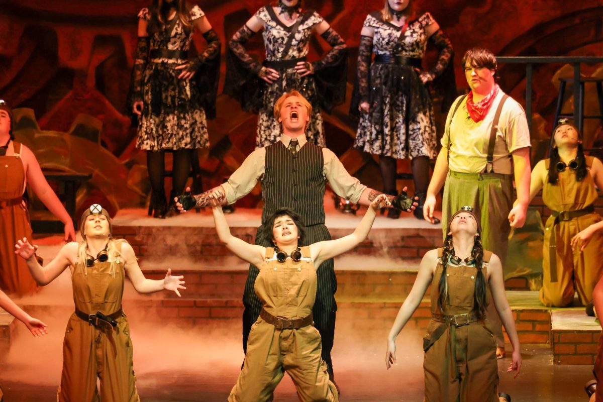Junior Cooper Laliberte preforming one of his songs in the role of Hades in Hadestown.